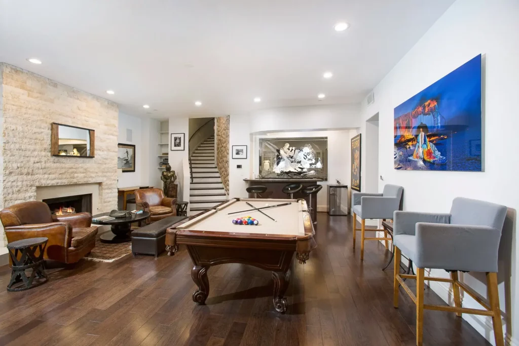 Legacy Healings luxury drug and alcohol rehab in Los Angeles, California, with game room equipped with a billards table, fireplace and seating.