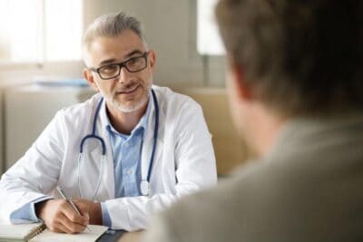 A doctor talking to a man about alcohol and blood pressure