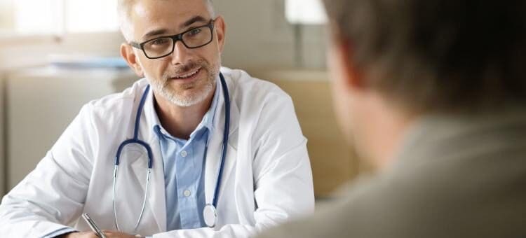 A doctor talking to a man about alcohol and blood pressure