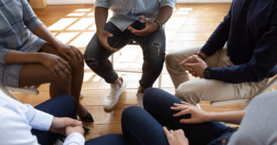 People sitting in a group in therapy