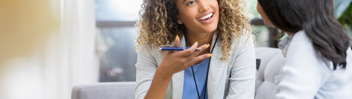 A woman meeting with her therapist in a one-on-one setting.