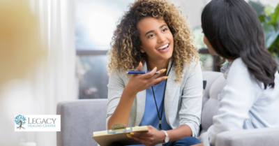 A woman meeting with her therapist in a one-on-one setting.